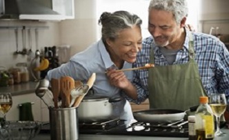 Older couple cooking together.